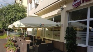 A hotel exterior with outdoor seating, a sign indicating 'New Hotel', and a logo for '3B'. - Hotel New (Baia Mare)