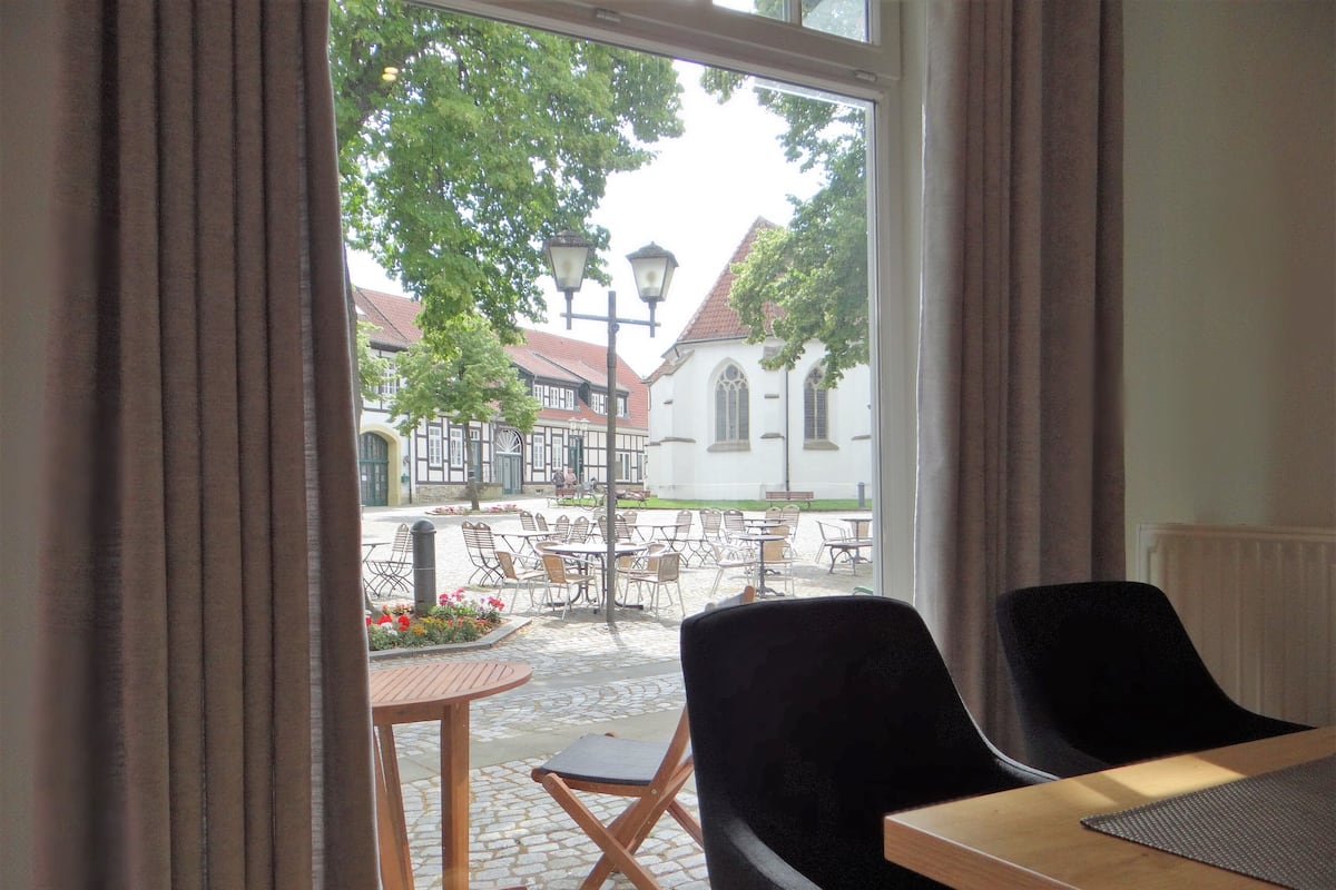 Deluxe Apartment | Living area | Flat-screen TV, books