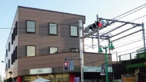 A modern building with multiple windows and a visible storefront. - Shin-Okubo International Hotel (Tokyo)