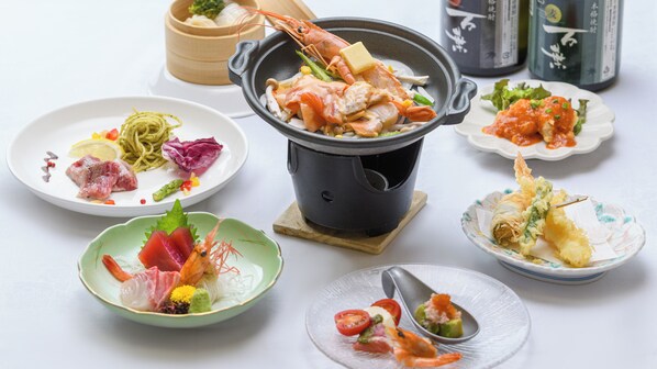 A variety of dishes including seafood, vegetables, and noodles, suggesting a diverse meal selection.