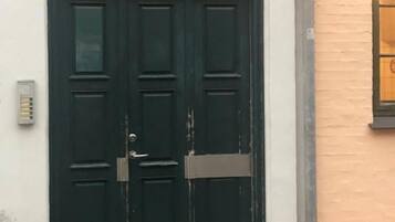 A dark green double door with a sign above it reading 'No 21 C'.