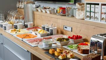 A buffet setup with various food items and condiments.