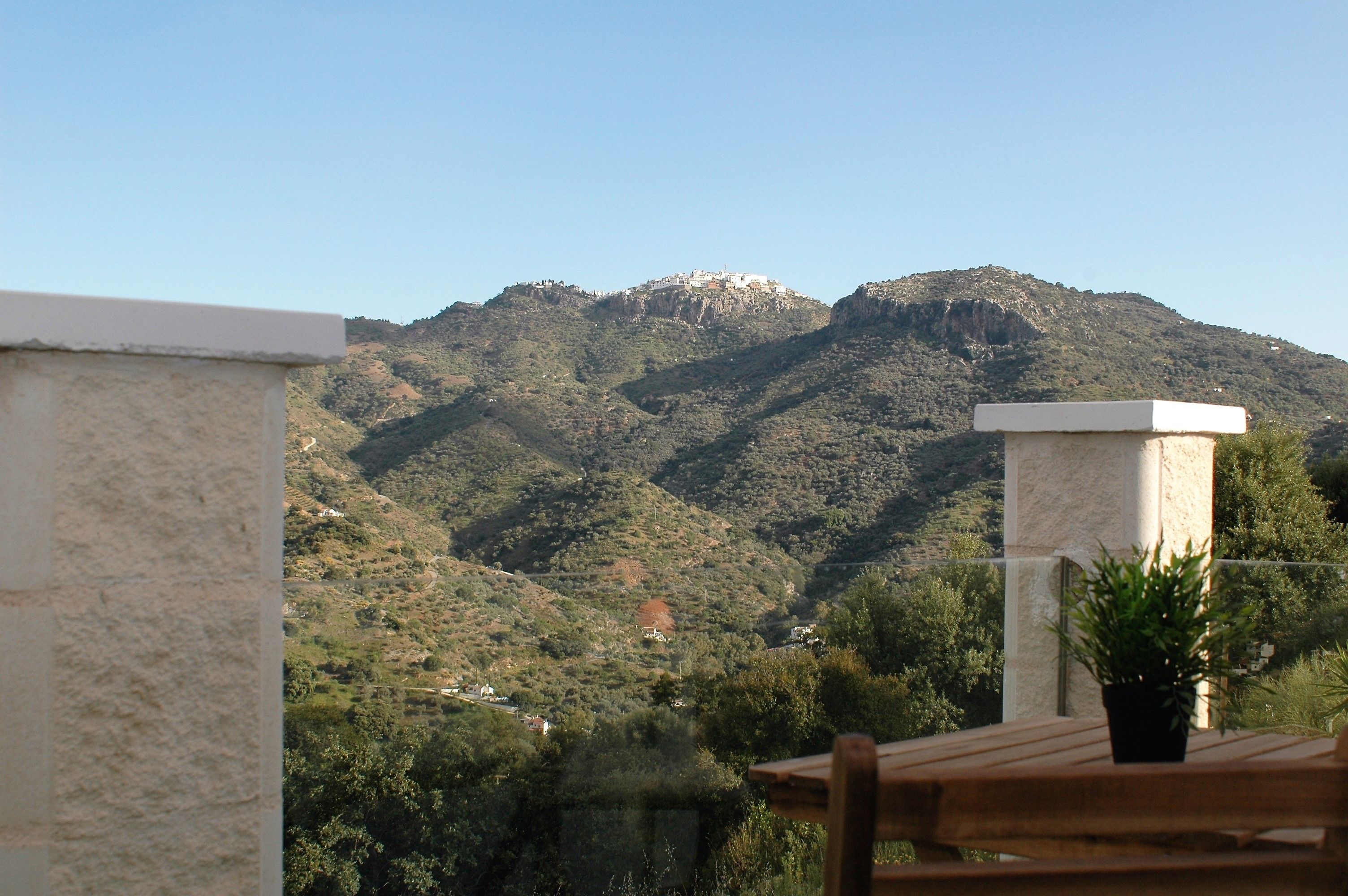 A mountainous landscape with a building on a hill.