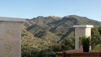 A mountainous landscape with a building on a hill.