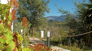 A pathway leading to a white building with a view of a mountainous landscape. - Jingtu Wellness & Spa Resort (Comares)