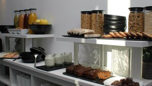A buffet with various food items including fruits, cereals, and desserts. - Jingtu Wellness & Spa Resort (Comares)