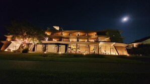 A modern, multi-story building with large windows and a unique architectural design.