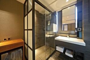 A modern bathroom with a glass-enclosed shower, a wooden vanity, and a large mirror. - Micro Hotel (Taichung)
