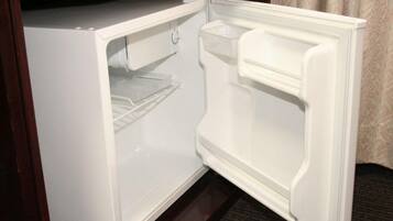A white refrigerator with a freezer compartment on the left and a main compartment on the right.