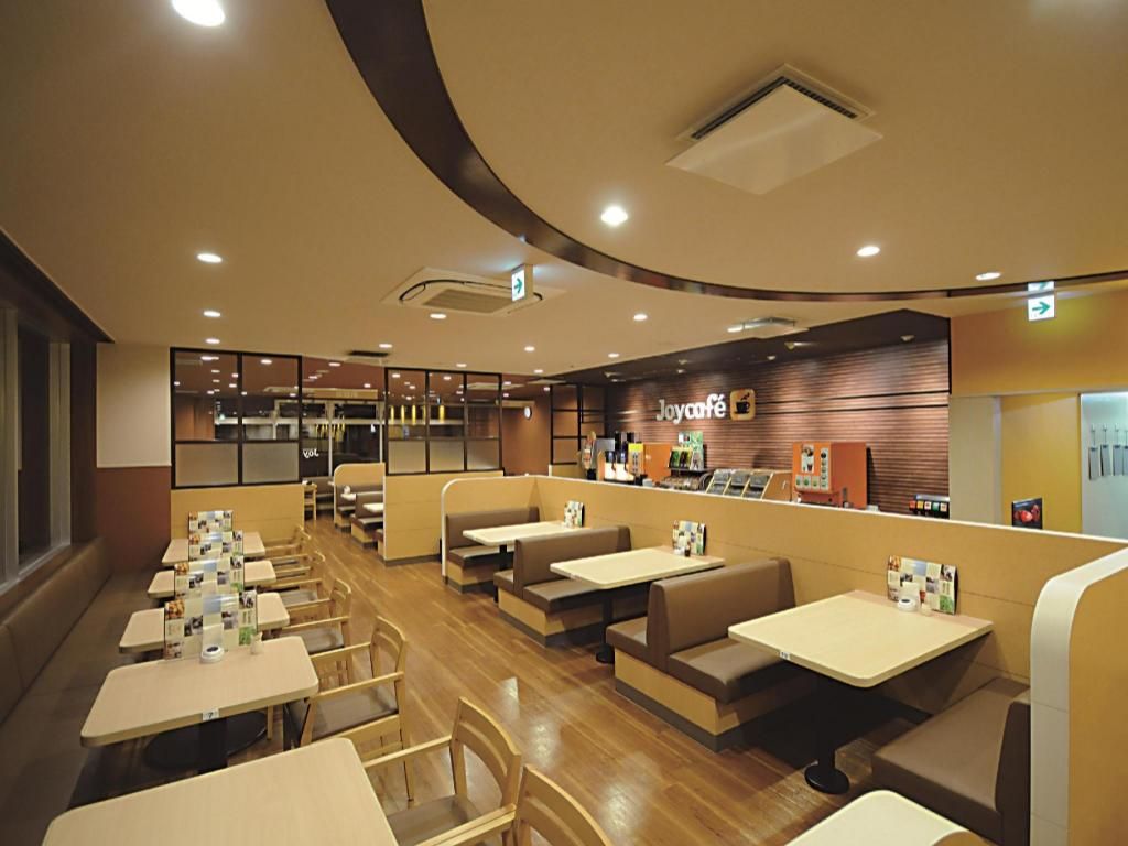 A restaurant with booths and tables, a counter with a menu, and a sign that reads 'Joycafé'.