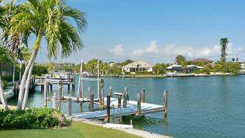 A marina with docks, boats, and a clear sky.