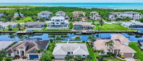 A residential area with houses, a marina, and a view of the ocean.