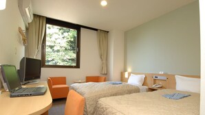 A hotel room with two beds, a desk with a laptop, a TV, and a window with curtains. - Hamada NEW Castle Hotel (Hamada)