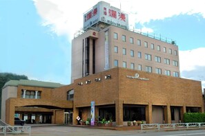 A hotel with a prominent sign on the top, a brick facade, and a series of windows. - Yuzawa Royal Hotel (Yuzawa)