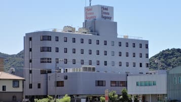 A multi-story hotel building with a sign indicating 'Hotel Ermou Regency.'