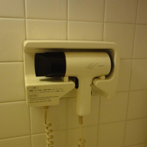 A hair dryer mounted on a wall with a cord. - Hotel Elm Regency (Shimizu)