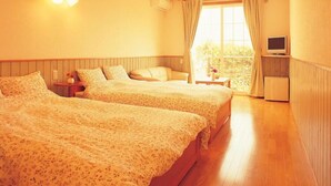 A hotel room with two beds, a TV, a window with curtains, and a small table with a vase. - Hidamari Inn Futama (Kamogawa)