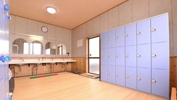 A public restroom with a wooden floor, a sink area with mirrors, and a row of lockers.