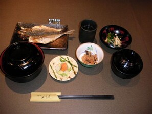 A meal setup with a fish, bowls, and chopsticks on a table. - Business Hotel Lend (Kawaguchi)