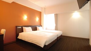 A hotel room with a large bed, two bedside tables, a desk, and a TV mounted on the wall. - Ab Hotel Komaki (Komaki)