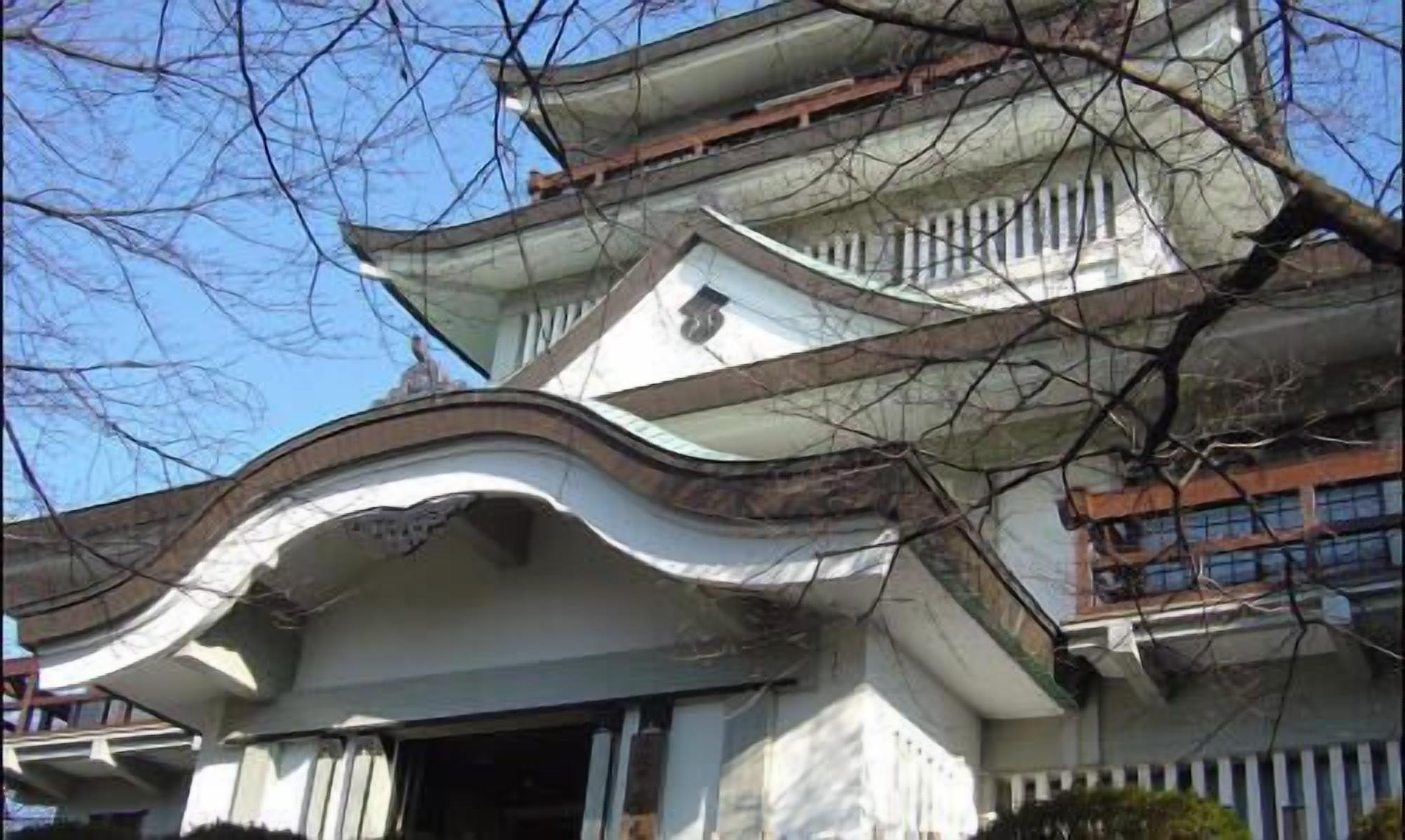 A traditional building with multiple levels and a curved roofline.