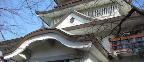 A traditional building with multiple levels and a curved roofline.