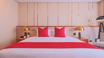 A hotel room with a large bed, two bedside tables, a lamp, and a chair.