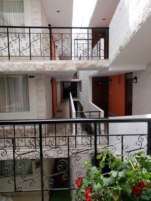 A multi-level residential building with a central staircase connecting the floors.