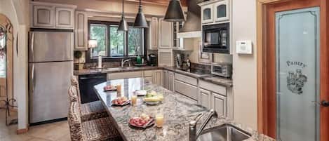 Fridge, microwave, coffee/tea maker, cookware/dishes/utensils