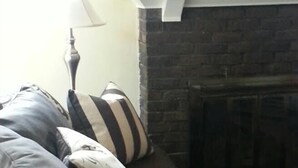 A living room with a sofa set, a fireplace, and a lamp. - Butte Bungalow Home, Close to uptown- 2 bdrm, 2 bath, No Cleaning fee (Butte)