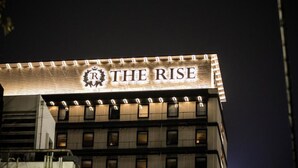 A building with a sign that reads "THE RISE" illuminated at night. - The Rise Osaka Kitashinchi (Osaka)