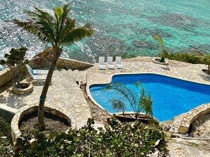 Large Pool with Native Stone Patio Overlooks the Ocean and reefs.  