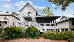 A two-story building with a balcony and a covered porch area.