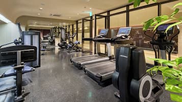 A gym with treadmills, weight machines, and exercise bikes.