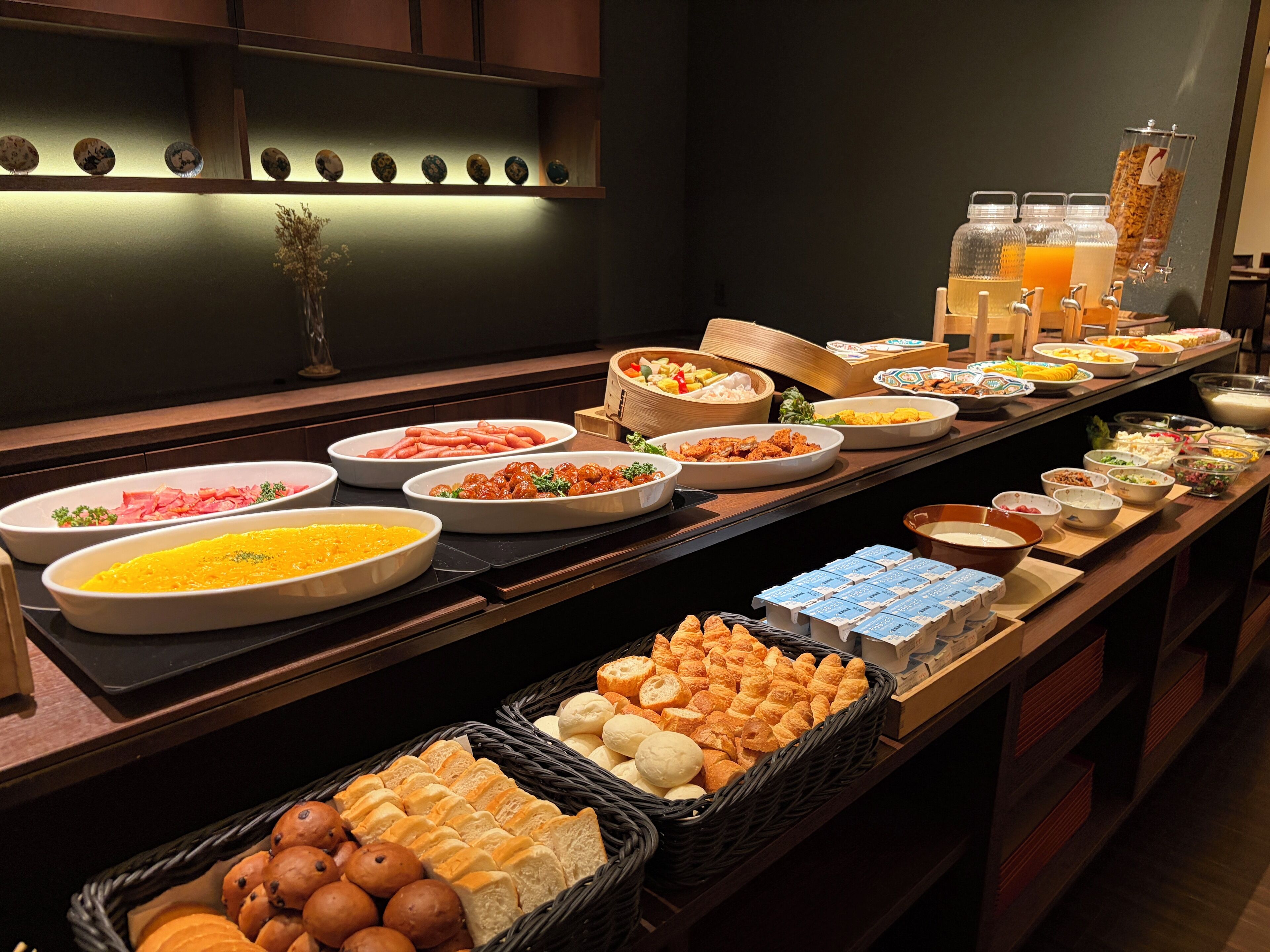 A buffet with various food items and beverages.