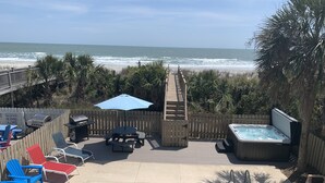 A pool area with a view of the ocean, a hot tub, and lounge chairs. - 5 Bedroom & 5 Bath Beachfront House w/ Private Pool, Hot Tub & Beach Boardwalk! (Surfside Beach)