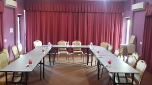 A conference room with a long table, chairs, and water bottles.