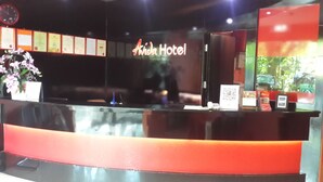 A reception desk with a sign that reads "Avida Hotel".