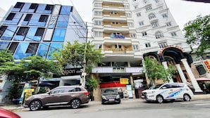 A hotel with a modern facade, multiple floors, and a prominent sign. - Sabay Airport Apartment (Ho Chi Minh City)
