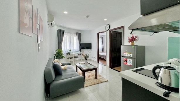 A modern apartment with a living room, dining area, and kitchen. - Sabay Airport Apartment (Ho Chi Minh City)