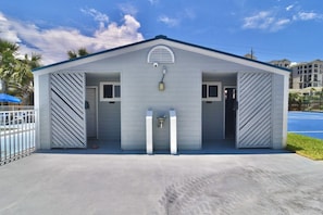 A building with a gabled roof, two doors, and a small window. - B 34 Sundown Condominiums (Pensacola)