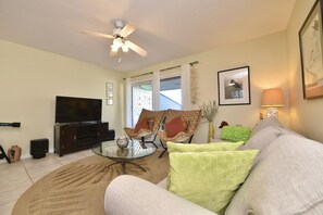 A living room with a sofa, armchairs, a TV, and a ceiling fan. - B 34 Sundown Condominiums (Pensacola)