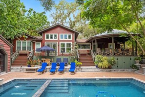 A two-story house with a swimming pool, outdoor seating, and a covered patio area. - Mills Cottage by the Little Lake (Orlando)