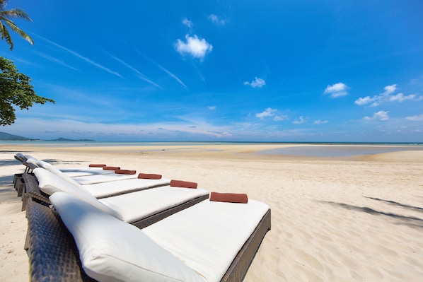 On the beach, sun loungers, beach towels