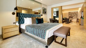 A modern bedroom with a large bed, bedside tables, a bench, a desk, and a chair. - Lemon Tree Hotel Viman Nagar Pune (Pune)