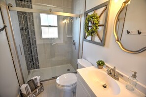 Shower, hair dryer, towels, toilet paper