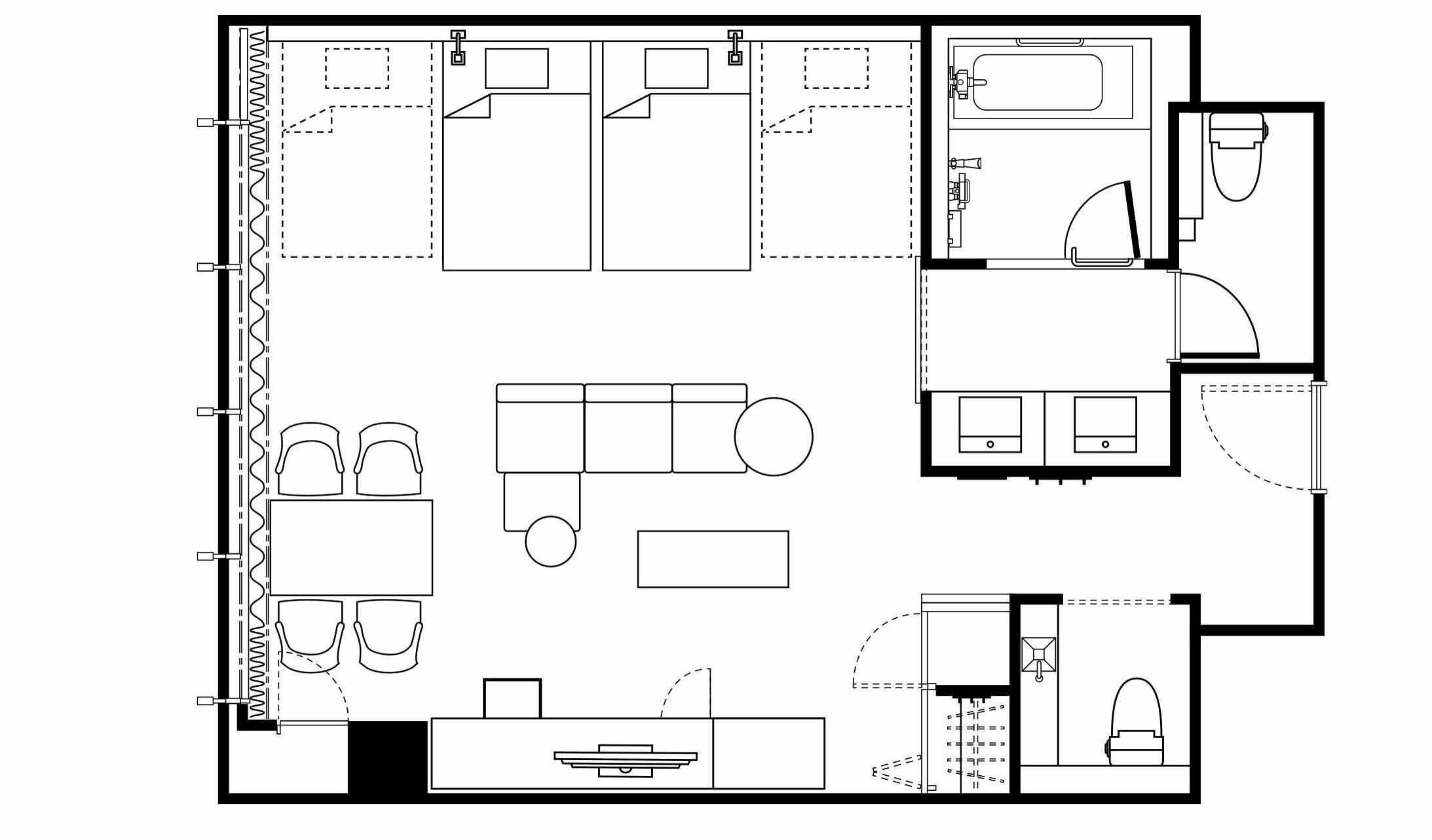 A floor plan of a hotel room with a bed, a desk, a chair, a small table, a sofa, and a bathroom.