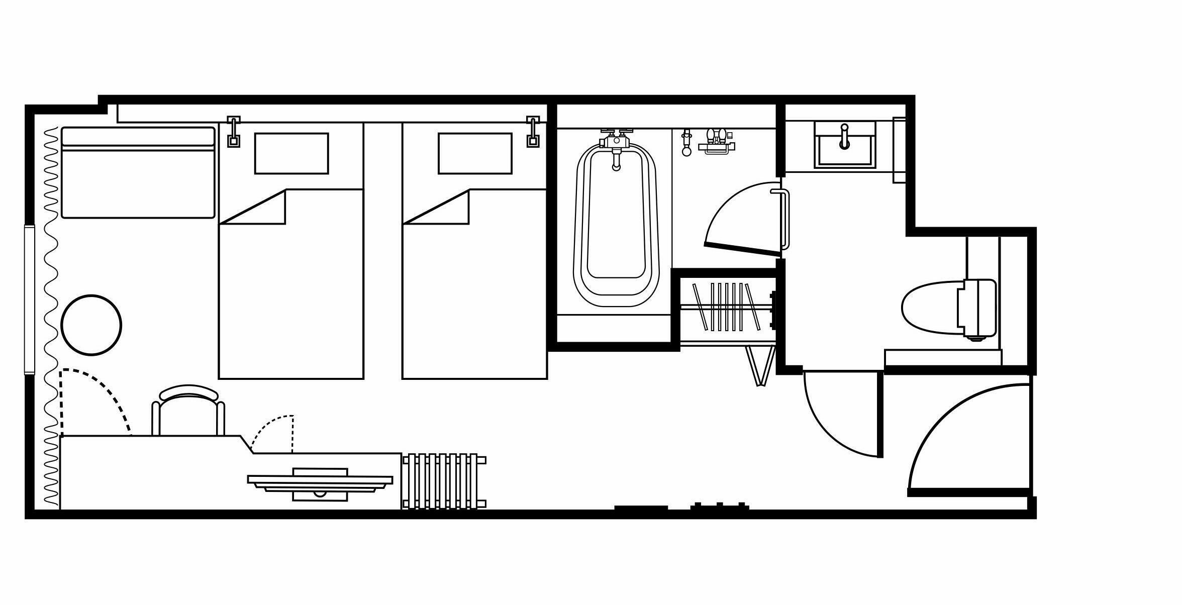 A floor plan of a hotel room with a bathroom, a kitchenette, and a small seating area.