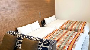 A hotel room with two beds, each with white linens and patterned blankets. - Rakuten STAY Villa Miyakojima (Miyakojima)