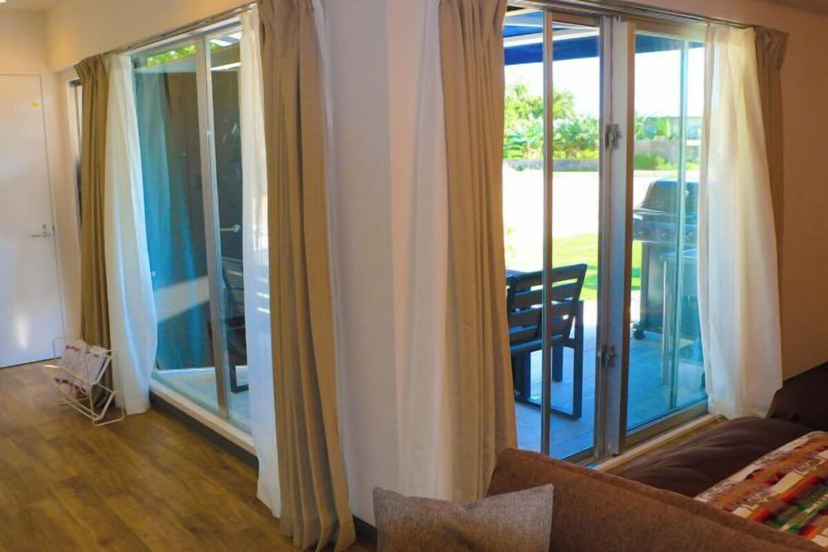 A room with a sliding glass door leading to an outdoor patio area.